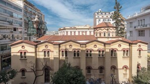 A historic building with a central dome, surrounded by modern high-rise buildings. - Stylish Studio KingBed&Workspace-WkndNse (Athina)