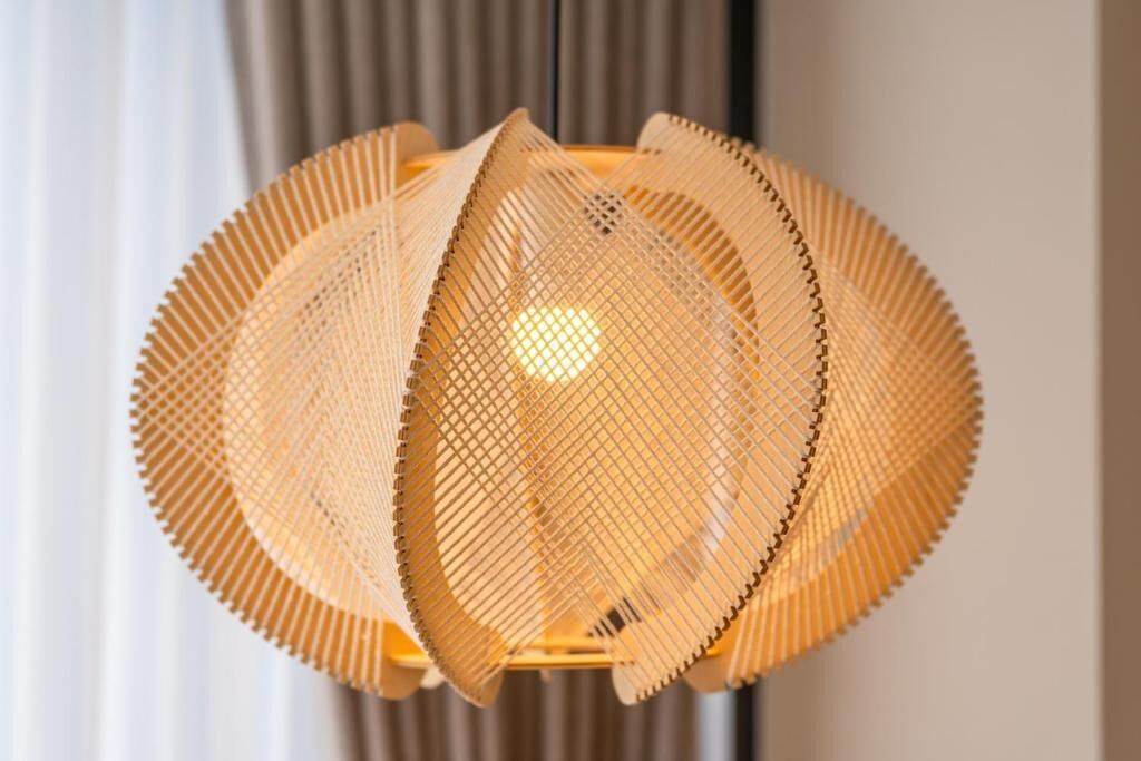 A circular, woven light fixture with a central bulb.