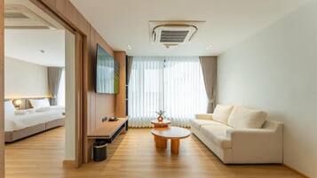 Suite, City View | Living area | TV