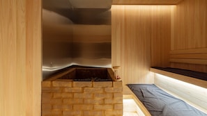 A sauna room with a brick base, wooden walls, and a bench. - Loop Seoul Hotel Retreat by Anook Seoul Gangnam 2 (Seoul)