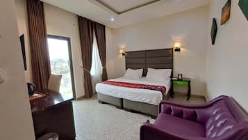Family Room, Balcony, City View | Desk, laptop workspace, blackout drapes, soundproofing