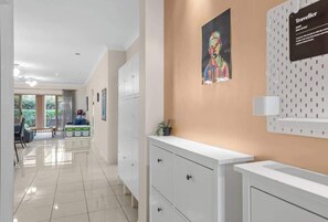 A modern hotel lobby with a reception desk, a waiting area, and a view of the outdoors. - Open Plan! 3 Bedroom House - Taringa (Brisbane)