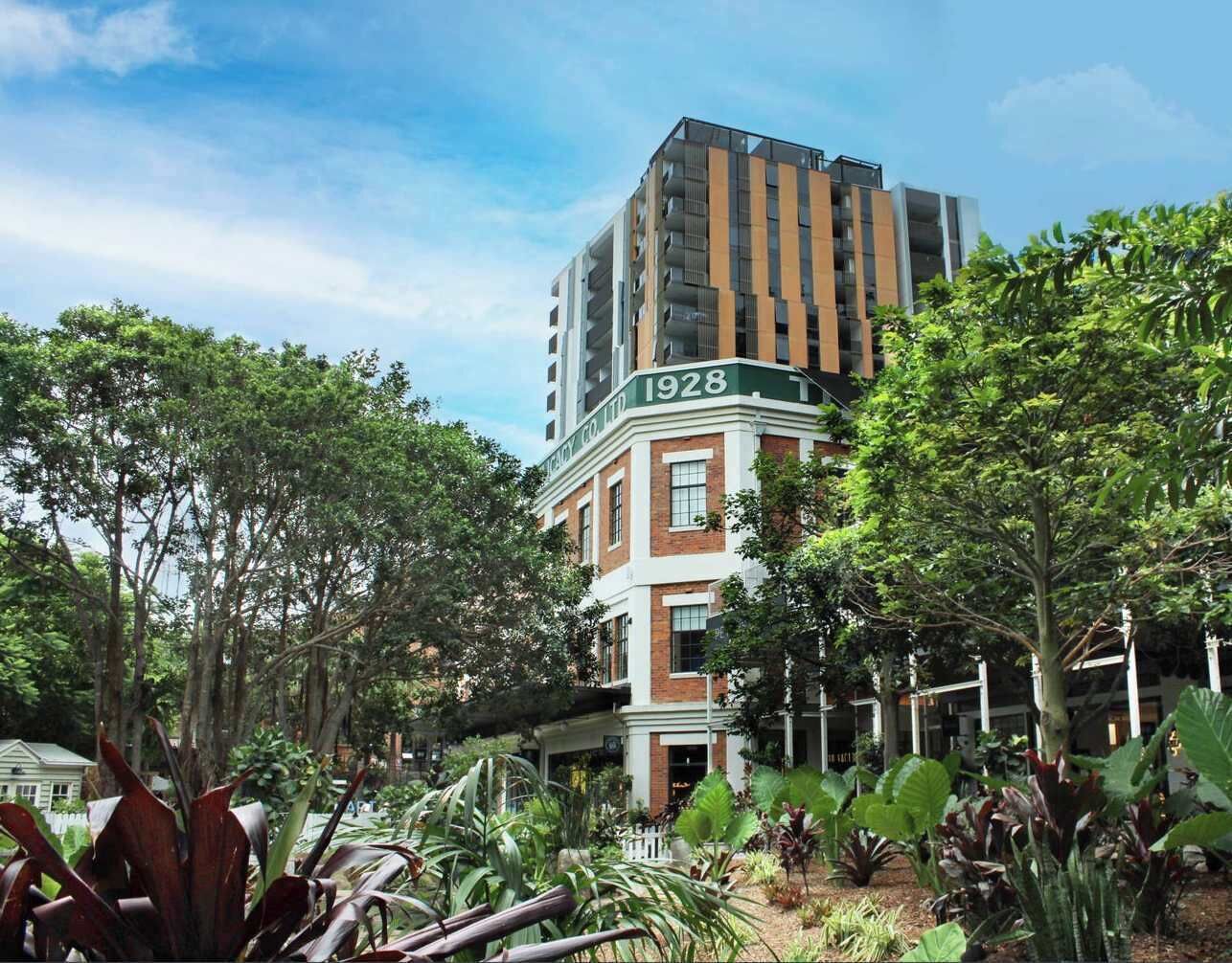 A building with the number 1928, surrounded by lush greenery and trees.