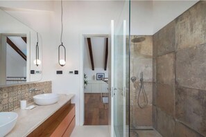 A modern bathroom with a glass shower enclosure, a white sink, and a large mirror. - Villa Sound of Silence (Danilo Gornje)