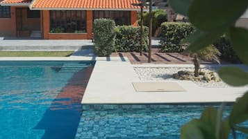 Seasonal outdoor pool, open 9:00 AM to 9:00 PM, pool loungers