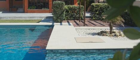 Seasonal outdoor pool, open 9:00 AM to 9:00 PM, sun loungers