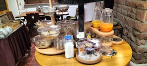 A breakfast buffet with various food items and beverages.