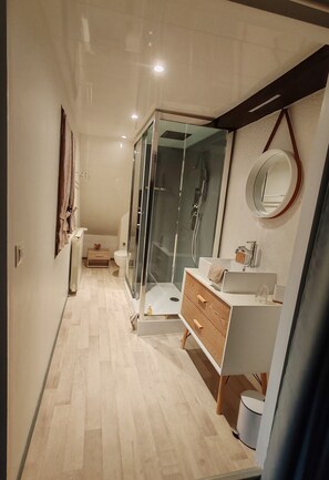 A modern bathroom with a glass shower enclosure, a wooden vanity, and a white sink. - Sans Chichi Chambres et Table: Mountain View, Shared Terrace & Wi-Fi (Escandolières)