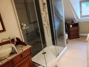 A bathroom with a glass-enclosed shower, a sink with a towel, and a wooden cabinet. - “Sans Chichi Chambres Et Table” Guesthouse with Shared Terrace, Garden, and Wi-Fi (Escandolières)
