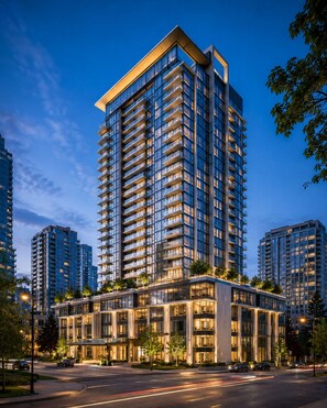 A high-rise building with multiple balconies, a modern glass facade, and a well-lit entrance area. - Sunway Pyramid by Resort Suites (Petaling Jaya)