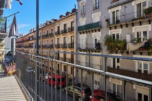 A multi-story residential building with balconies, a pedestrian walkway, and parked cars. - Fontana | The Rentals Collection (San Sebastián)
