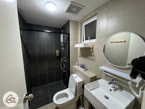 A bathroom with a shower, toilet, sink, mirror, and towel rack. - Trival Blessing Cottage Homestay @ Sri Indah Sandakan (Sandakan)