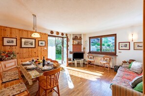 A cozy interior with a dining area, a living room, and a fireplace. - Family Apartment Steps From Ski Lifts (Courmayeur)
