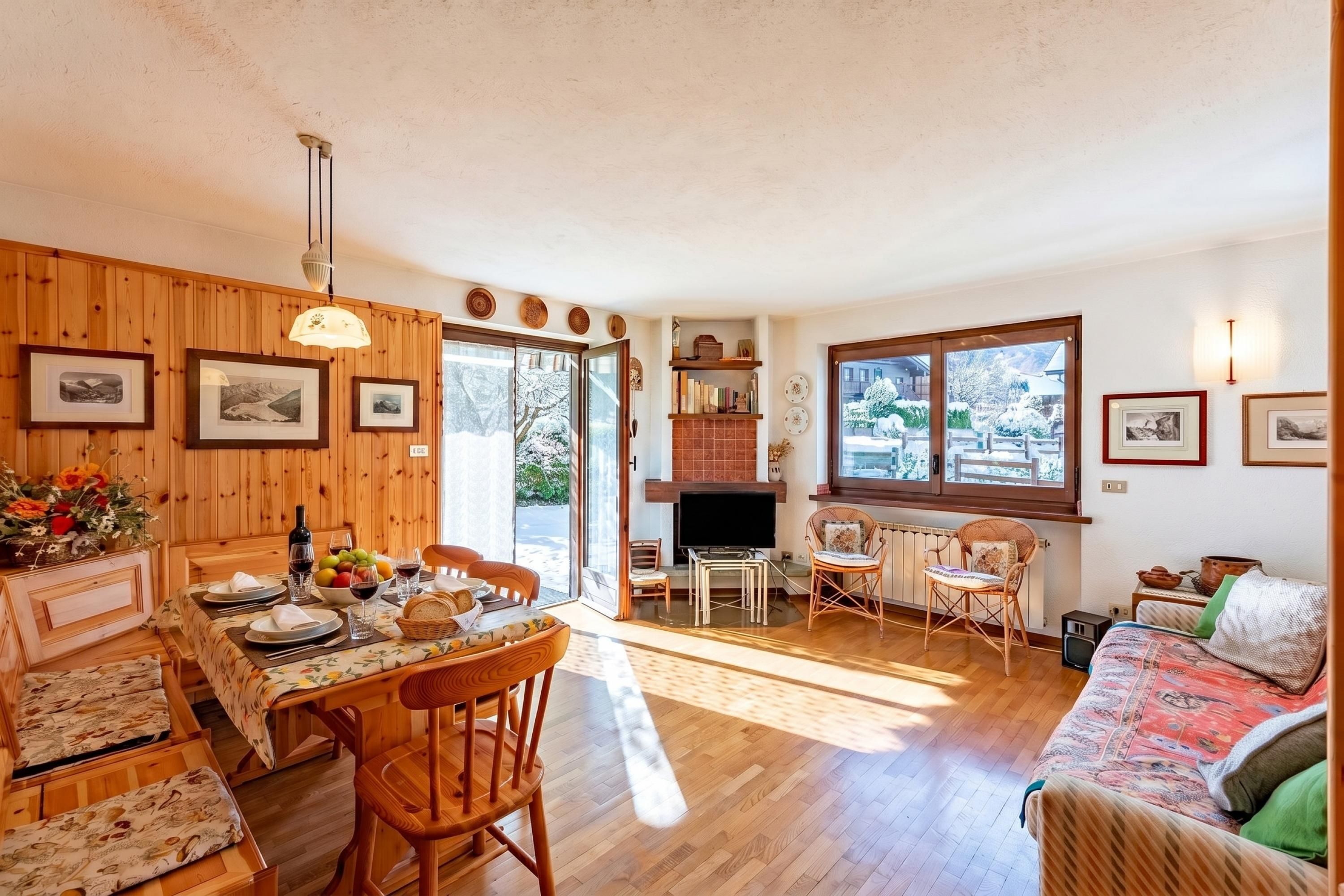 A cozy interior with a dining area, a fireplace, a television, and a sofa.