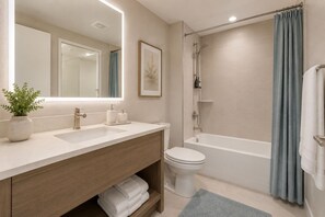 A modern bathroom with a sink, toilet, and shower. - The Aeris Suites (Toronto)