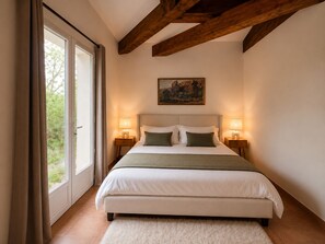 A bedroom with a large bed, two bedside tables, a painting on the wall, and a view through the window. - Villas between Provence and nature on the Château Roubine estate (Lorgues)