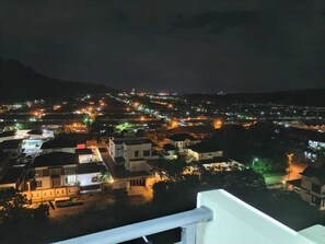 A nighttime view of a town with illuminated buildings and streets. - Trival Double 9 Homestay @ Sri Indah Sandakan (Sandakan)