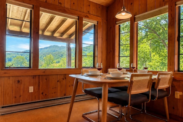 The dining area seats four and overlooks Deep Creek and Sharp Top mountain in the distance.