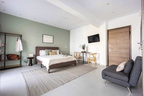 A modern bedroom with a bed, a sofa, a TV, and a desk. - Stylish Studio l Balcony l No Elevator (Athens)