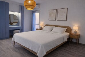 A bedroom with a bed, bedside lamps, a mirror, and two wall art pieces. - MISK Marina Valley Alamein (Alamein)