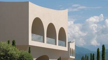 A modern building with three arched windows and a flat facade.
