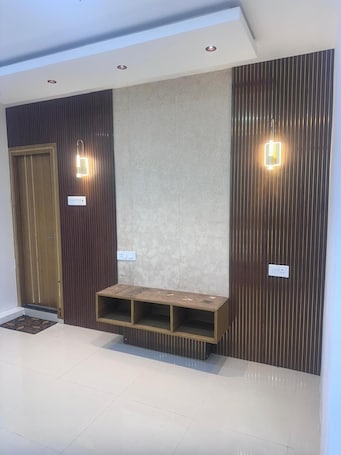 A modern interior with a wooden door, recessed lighting, and a built-in bench.. Hotel Krishna & Restaurant