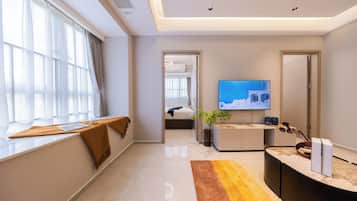 Family Suite, Balcony, Garden View | Desk, laptop workspace, blackout drapes, soundproofing