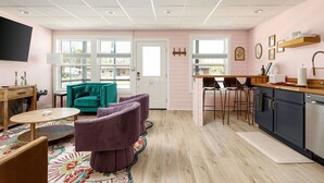 A modern apartment with a living room, kitchen, and dining area. - Timberline 3 Lower Units (Traverse City)