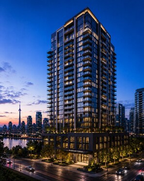 A high-rise building with multiple balconies, a prominent entrance, and a view of the city skyline. - Greenfield residence by sunway pyramid (Petaling Jaya)