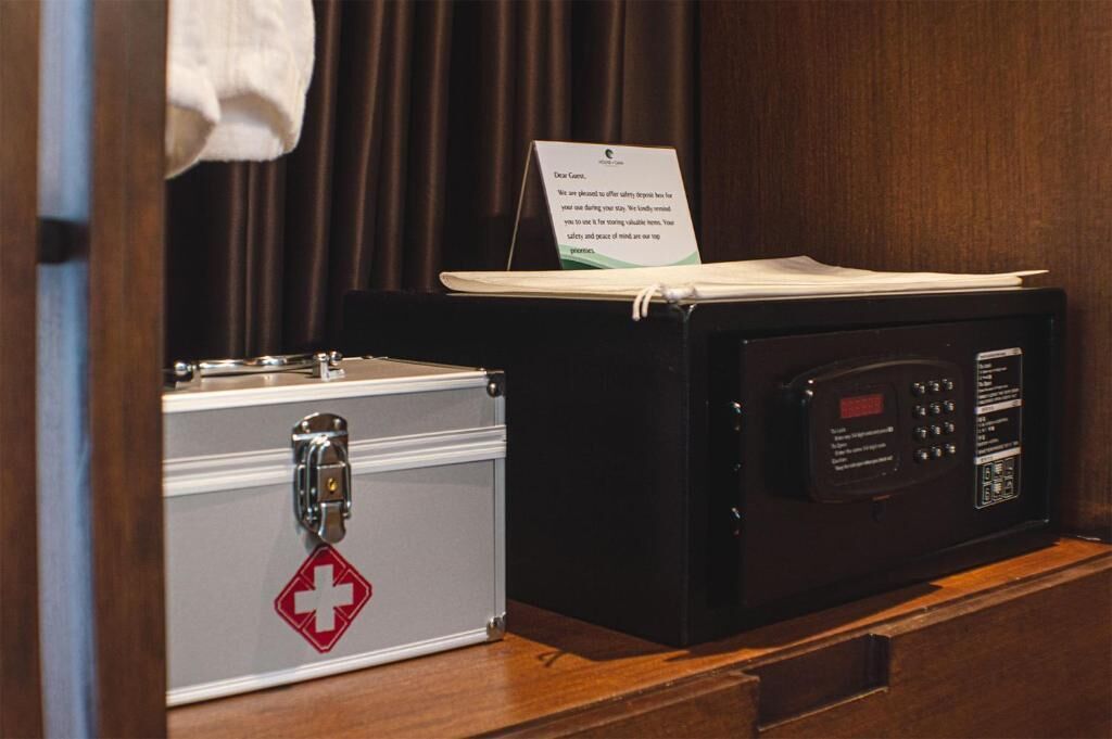 A medical kit and a microwave in a hotel room.
