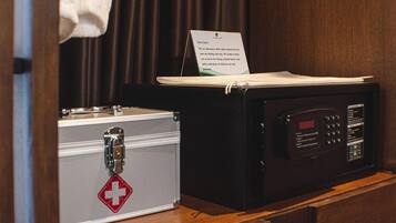 A medical kit and a microwave in a hotel room.