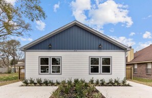 A single-story house with a gabled roof, two windows on the front, and a number '1010' on the side. - FIFA fam!  3-bedroom townhome in excellent H-Town (Houston)