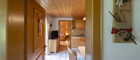 Un interno in legno con cucina, zona pranzo e soggiorno.