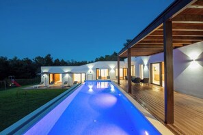 A modern building with a swimming pool, covered outdoor seating, and a play area. - Villa Istria Green (Kršan)