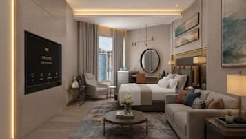 A modern hotel room with a TV, a desk, a bed, a sofa, and a coffee table.