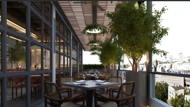 An outdoor dining area with a table and chairs, large windows, and a view of the cityscape.