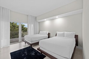 A modern bedroom with two beds, a balcony, and a large window. - Spacious Signature 3BR Villa for Golf & Family (Miami)