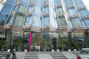 A modern building with large glass windows and a reflective facade.