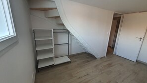 A staircase with a metal handrail and a white wall.