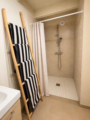 A shower with a handheld showerhead, a white curtain, and a tiled floor. - New - Private Garden - Near Aix Centre (Aix-en-Provence)