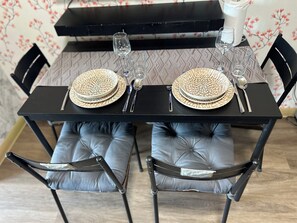 A dining table set with plates, cutlery, and glasses. - Family Condo SMB Live,Love & Laugh & have Fun (Pasay City)