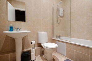 Un bagno completo di lavabo, WC, doccia e specchio.