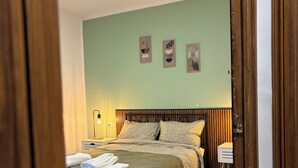 A bedroom with a bed, bedside table, wall art, and a door frame. - 3 Bedrooms by Ruzafa, metro 1 min, A/C (València)