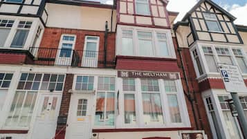 A traditional building with a sign reading 'The Meltham.'