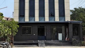 A modern building with a sign reading 'Radnavan' and multiple windows. - Hotel Shri Radhavan (Mathura)