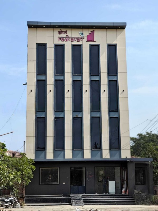 A modern building with a sign reading 'Radnavan' and multiple windows. - Hotel Shri Radhavan (Mathura)