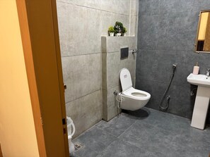 Deluxe Triple Room | Bathroom | Shower, free toiletries, towels, soap - Hotel Shri Radhavan (Mathura)