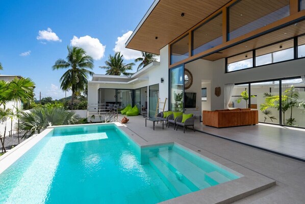 A modern house with a swimming pool, outdoor seating, and large windows. - Villa Mona | Stylish 3BR Pool Villa (Bo Put)