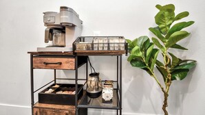 A coffee station with a Keurig machine, a coffee pot, and a tray with cups. - Modern Retreat l Sleeps 20+ l w/Loft Lounge (Houston)