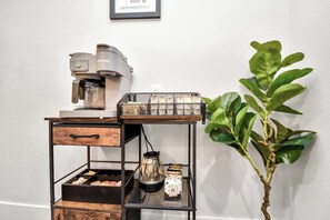 A coffee station with a Keurig machine, a coffee pot, and a tray with cups. - Modern Retreat l Sleeps 20+ l w/Loft Lounge (Houston)